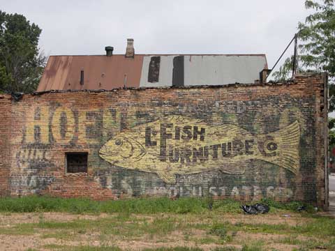 Old painted advertisement for L. Fish Furniture at 73rd and Halsted